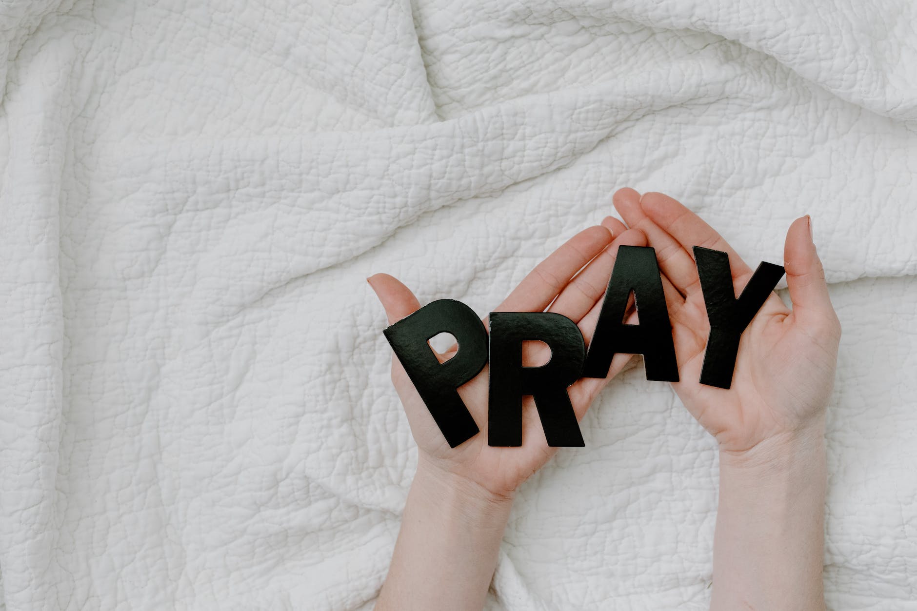 a person holding a black letters