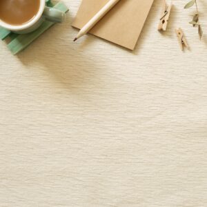 Work and study place. Cup of coffee, notepad, pencil, clip on beige fabric background. flat lay, top view, copy space
