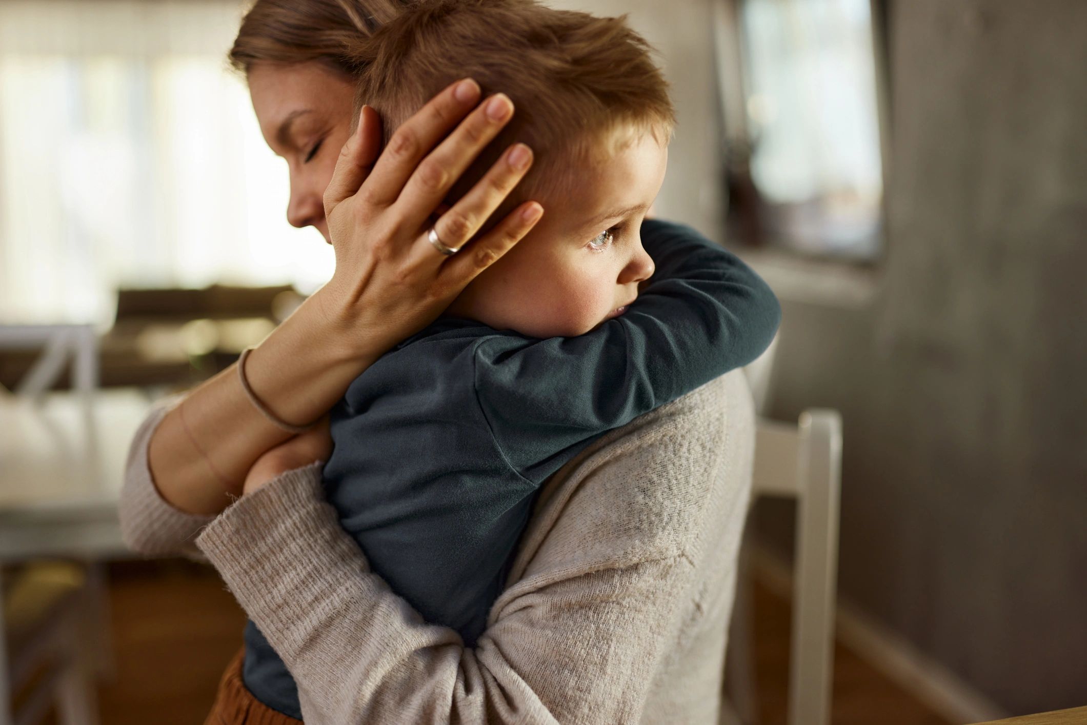 Mother comforting her child at home