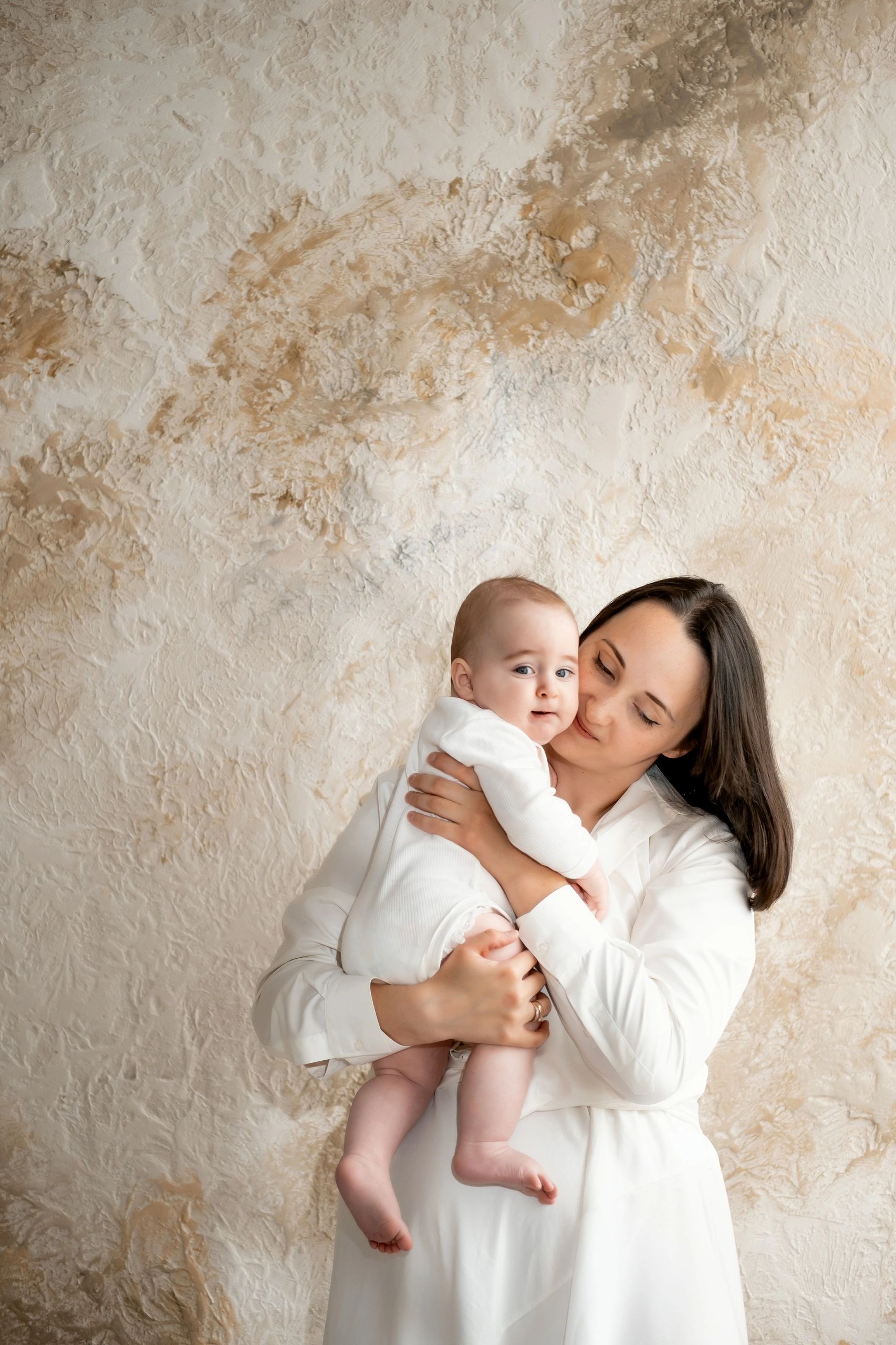Mother holding her baby with tenderness