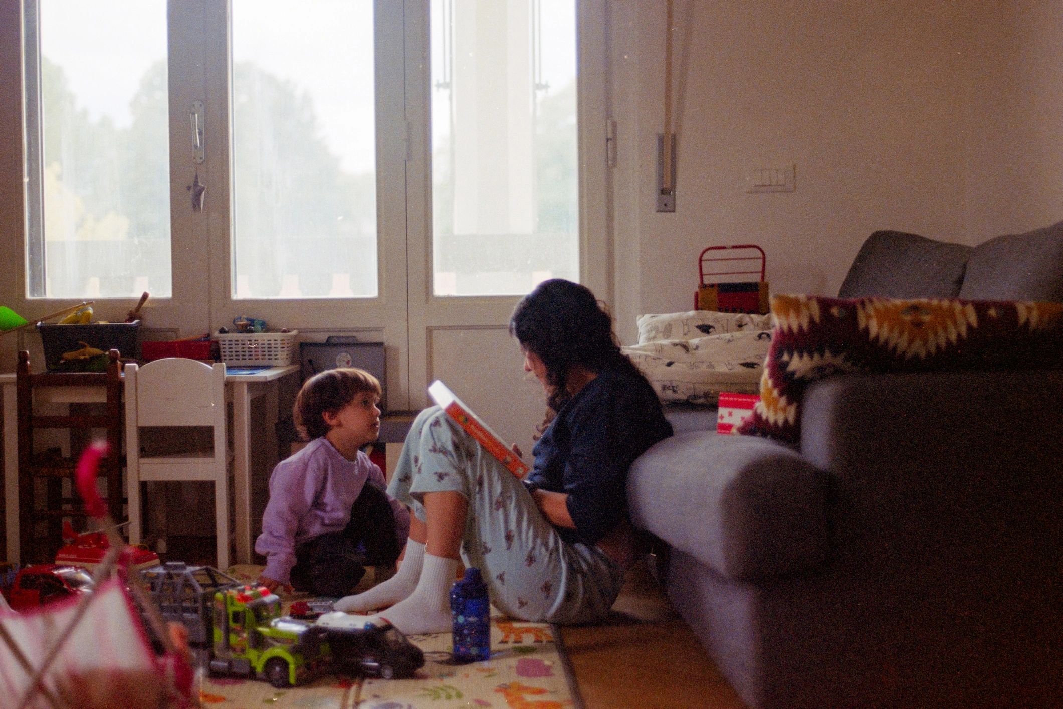 Mother reading with child at home